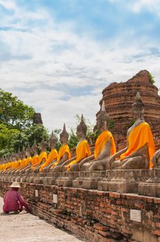 AYUTTHAYA,THAILAND-JUNE 27,2013: Walking around watyaichaimongkol .Some one like to preserve the 
archaeological site 
by pull or drag weed or unwanted flora