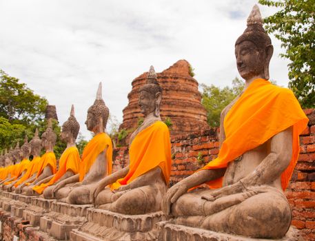 AYUTTHAYA,THAILAND-JUNE 27, 2013: Aligned statues of Buddha in Watyaichaimongkol