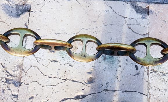Massive metal chain on sidewalk in Madrid, Spain