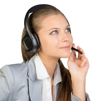 Businesswoman in headset, with her fingers on microphone boom, looking ahead and upward. Isolated over white background