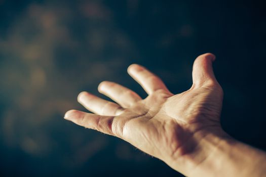 hands begging on a brown background