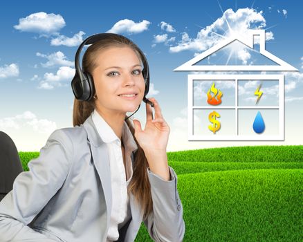 Businesswoman in headset, sitting on chair, her hand on microphone, looking at camera, smiling. Symbols of public utilities in house-shaped frame beside. Green hills and blue sky as backdrop