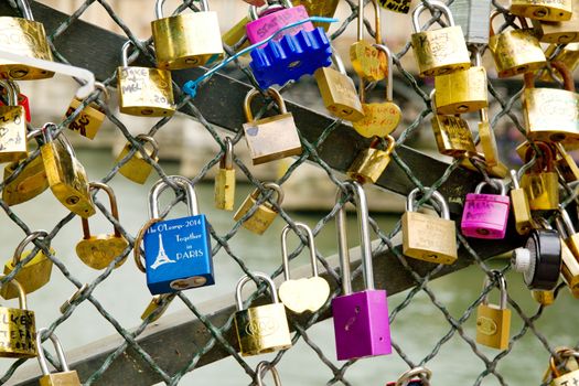Photo shows various Parisian love locks on the bridge.