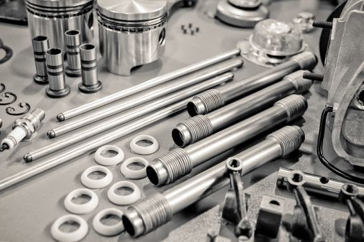 collection of precision auto engine parts laid out in a workshop