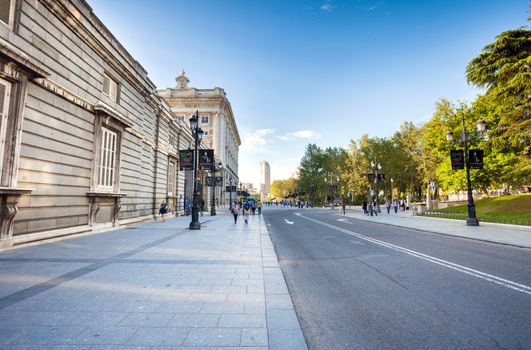 Madrid, Spain - May 6, 2012: Royal palace (Palacio Real de Madrid) with tourists and Torre de Madrid building on background on spring day in Madrid, Spain