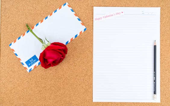 Cardboard, corkboard with note paper with pencil and rose beside for writing love letter, space for text