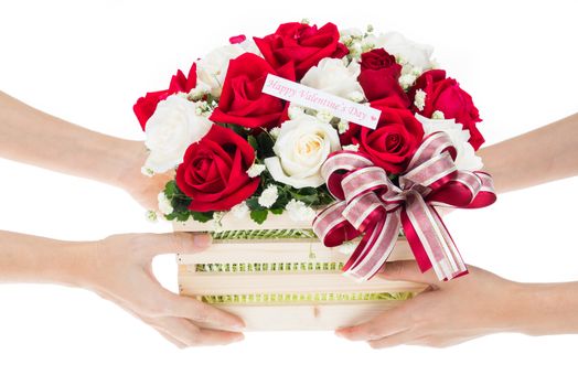 Hand delivers baskets of red and white rose flowers as a gift isolated on white background