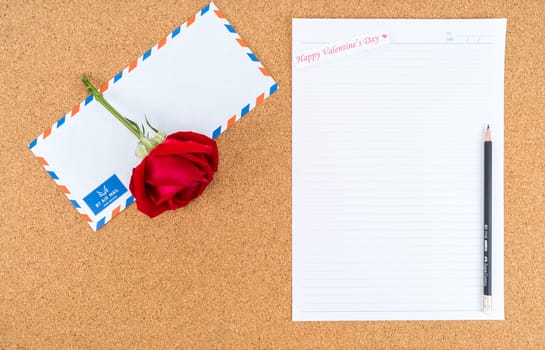 Cardboard, corkboard with note paper with pencil and rose beside for writing love letter, space for text