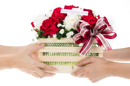 Hand delivers baskets of red and white rose flowers as a gift isolated on white background