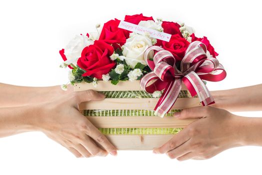 Hand delivers baskets of red and white rose flowers as a gift isolated on white background