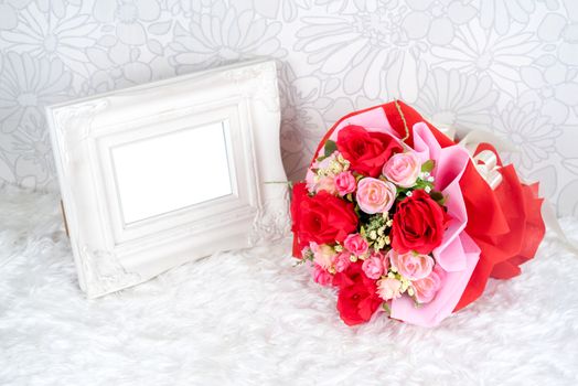 flowers bouquet placed with picture frame which have white space for your image