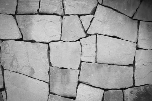 black and white multi-colored and multi-sized, pale rocks wall grunge texture background.