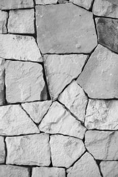 black and white and multi-sized, pale rocks wall grunge texture background.