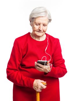Senior woman listening to music over white background