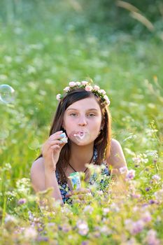 Young beautiful girl blowing bubbles