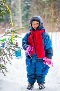 little boy and christmas tree outdoors