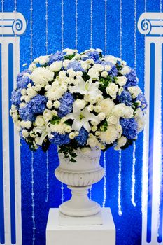 blue and white and green flowers in ceramic pot