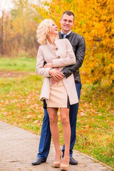 young couple walking in the park and laughing