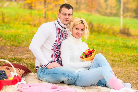 girl and her man on a picnic with a basket of fruit