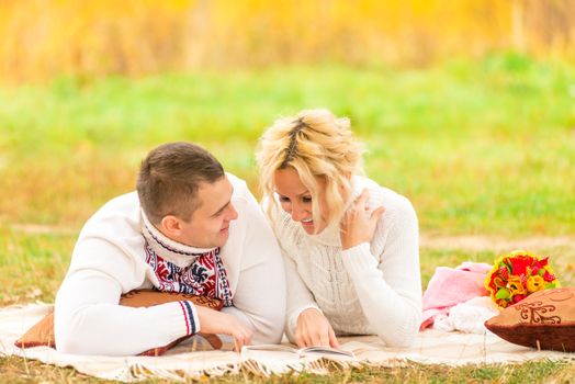 couple on a picnic together reading a novel