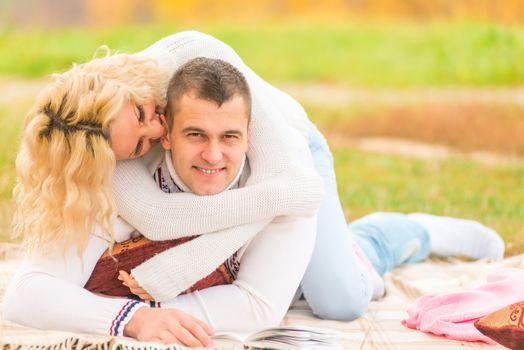 enamored girl bites the of her boyfriendbehind the ear