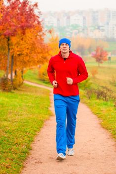 Male athlete jogging in the morning in the park