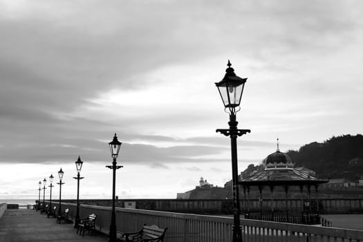 row of vintage lamps on the promenade in Youghal county Cork Ireland in black and white