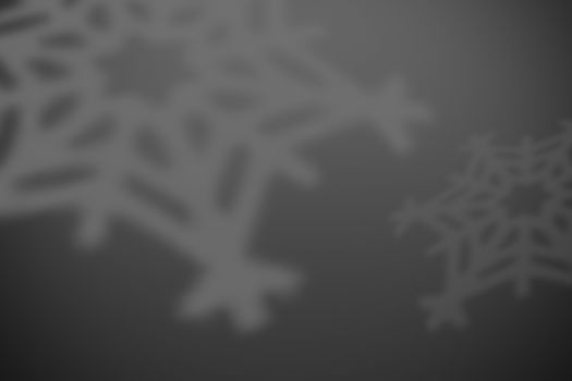 gray christmas background with defocused snowflakes