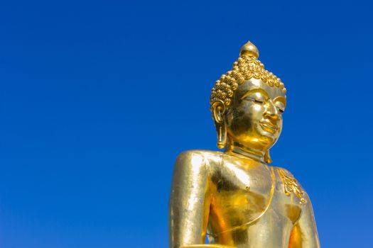 Big buddha isolated on  blue sky,Thailand, copyspace on the left.
