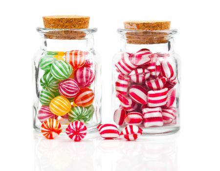 two filled glass candy jars isolated over white background