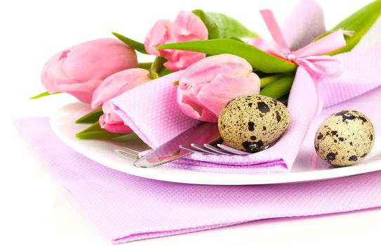 pink tulips with quail eggs in a plate, on a white background. romantic still life with fresh flowers