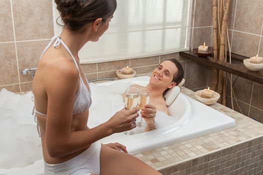 Couple making a toast in the tub