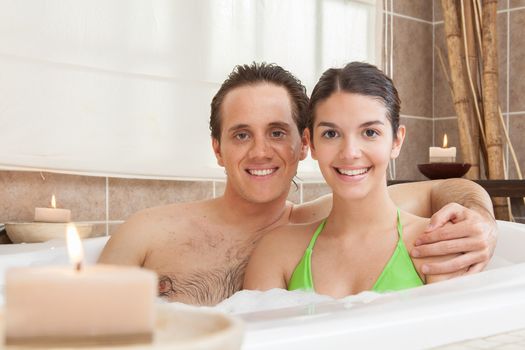 Happy couple relaxed in the tub