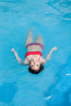 Woman floating in the pool