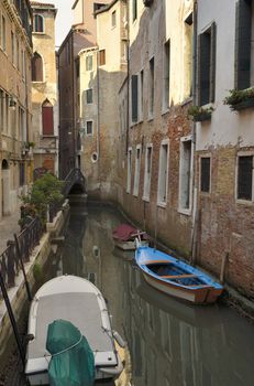 Boats parked at a narrow canal in Venice, Italy