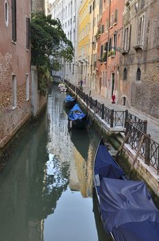 A couple walking quietly by a narrow street in Venice, Italy