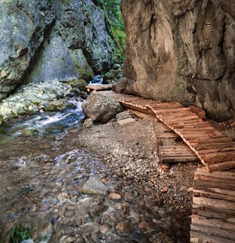 Wooden path around the creek in karstic canyon