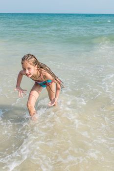 little girl on the sunny sea beach