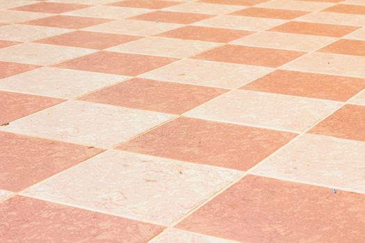 old and pale ceramic tiled floor of temple in thailand, outdoor.