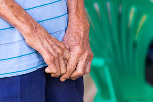 Closeup of an old man's hands joined , focus on hands.