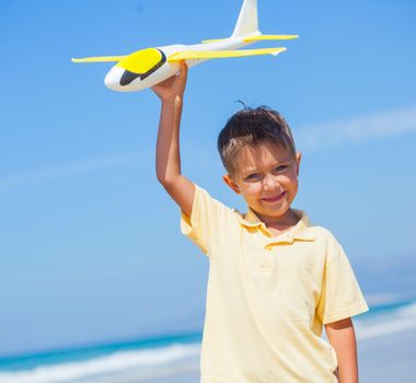 Portrait of beach kid boy kite flying outdoor coast ocean