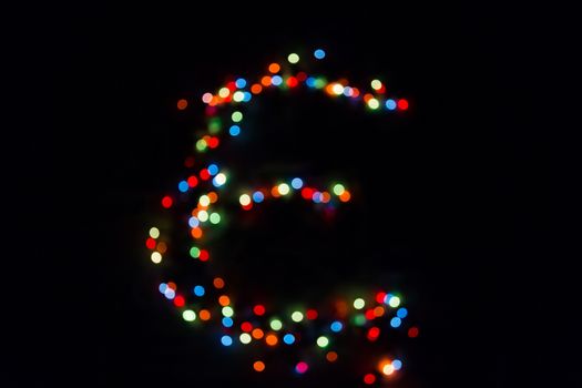 colorful letter E made of blurred circular bokeh on black background