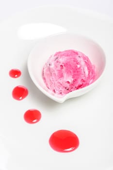 Raspberry layered cheese cake and pink ice cream ball, isolated on white