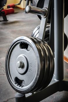 Gym interior with barbell plates holder rack