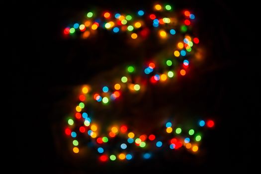 defocused colorful letter Z made of blurred circular bokeh on black background