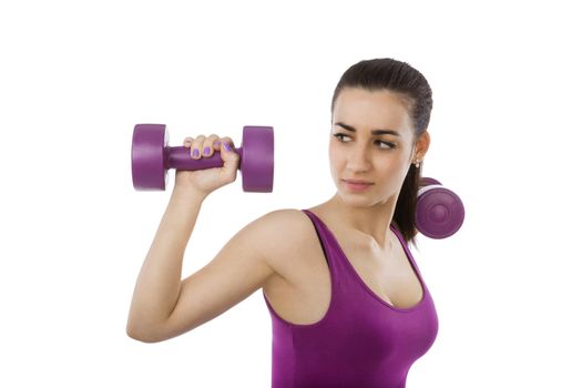 Beautiful girl with purple top and purple dumbbells isolated on white background. Sport and fitness, healthy living.