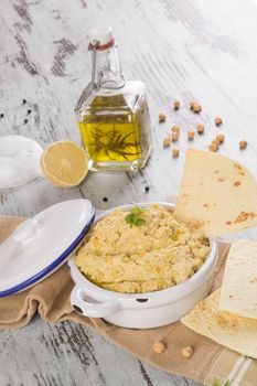 Olive oil, hummus, chickpeas and pepper corns isolated on white background. Culinary mediterranean cuisine. 