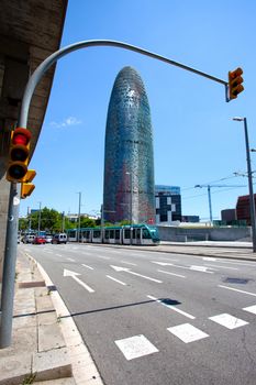 Spain, Catalunya, Barcelona 14.06.2013, the city's landscape with the building Torre Agbar, traffic lights and speed tram, editorial use only