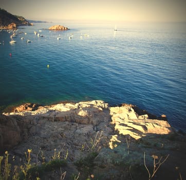 Mediterranean rocky sea coast at the summer evening, Badia de Tossa bay, instagram image style
