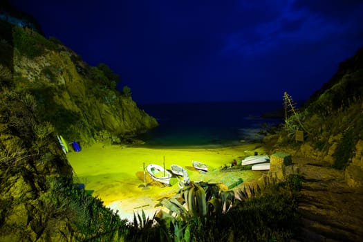 Tossa de Mar, Catalonia, Spain, 18.06.2013, a small bay of the Mediterranean, night landscape with boats on the beach
